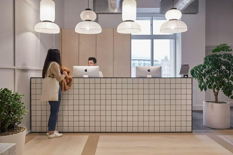 Tiled reception desk with warm pendant lighting at Waterloo Station, Suite 1, The Concourse, South Bank.