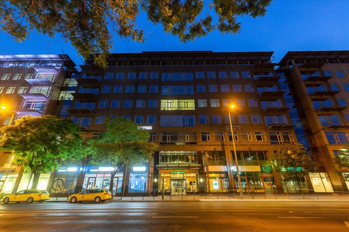 Exterior view of the contemporary facade of West End Business Centre at night.