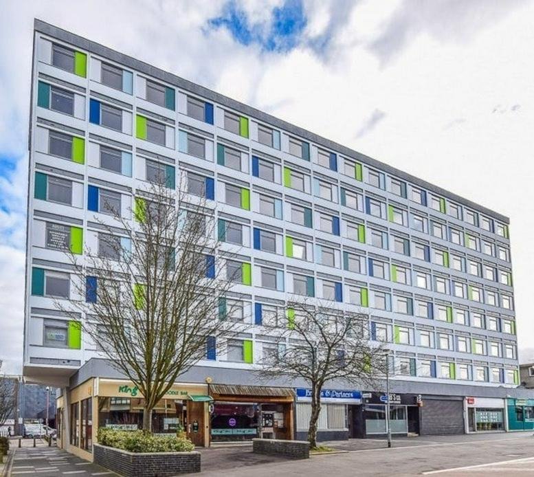 Exterior facade of Westgate House, The High, Harlow Town Centre with modern grey and green cladding.
