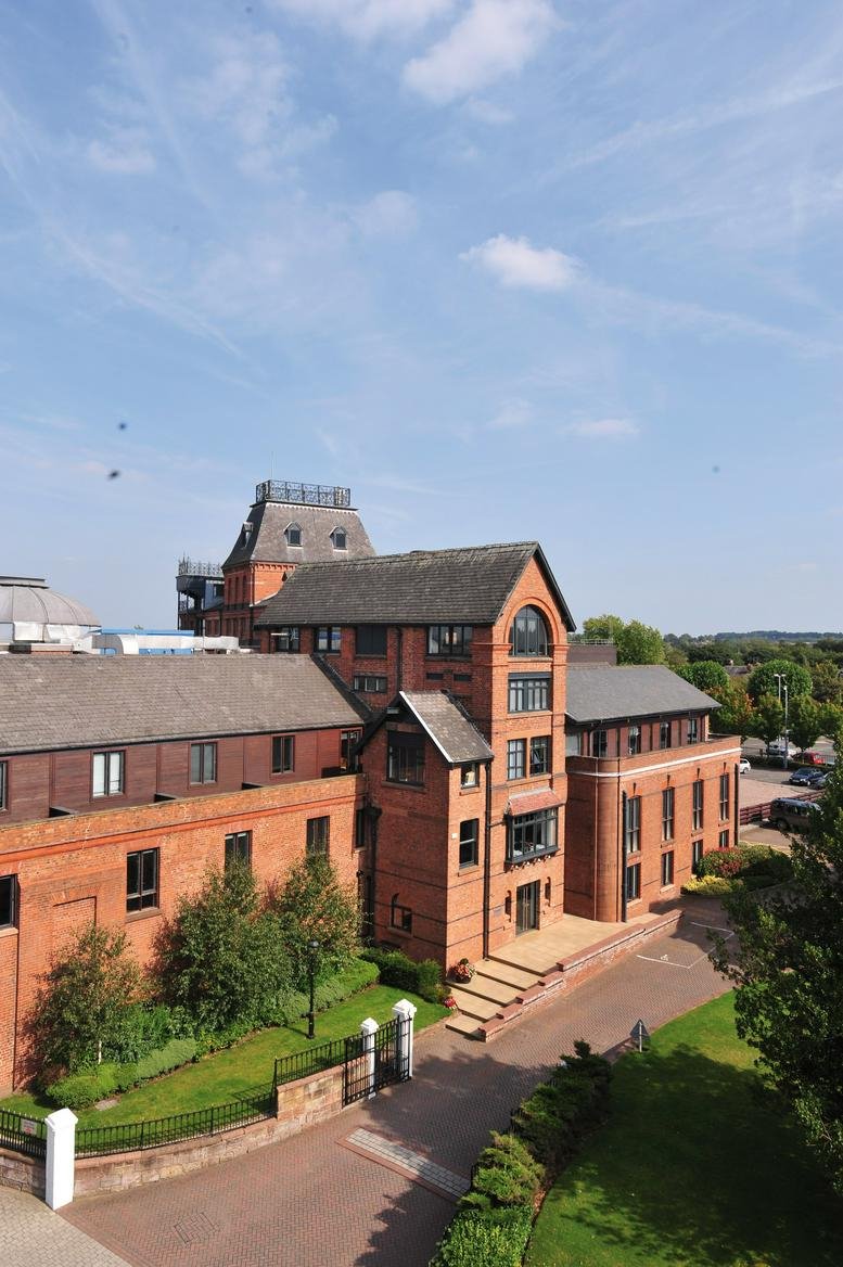 Exterior view of the red brick Wilderspool Business Park, Greenalls Avenue, Stockton Heath, Warrington.