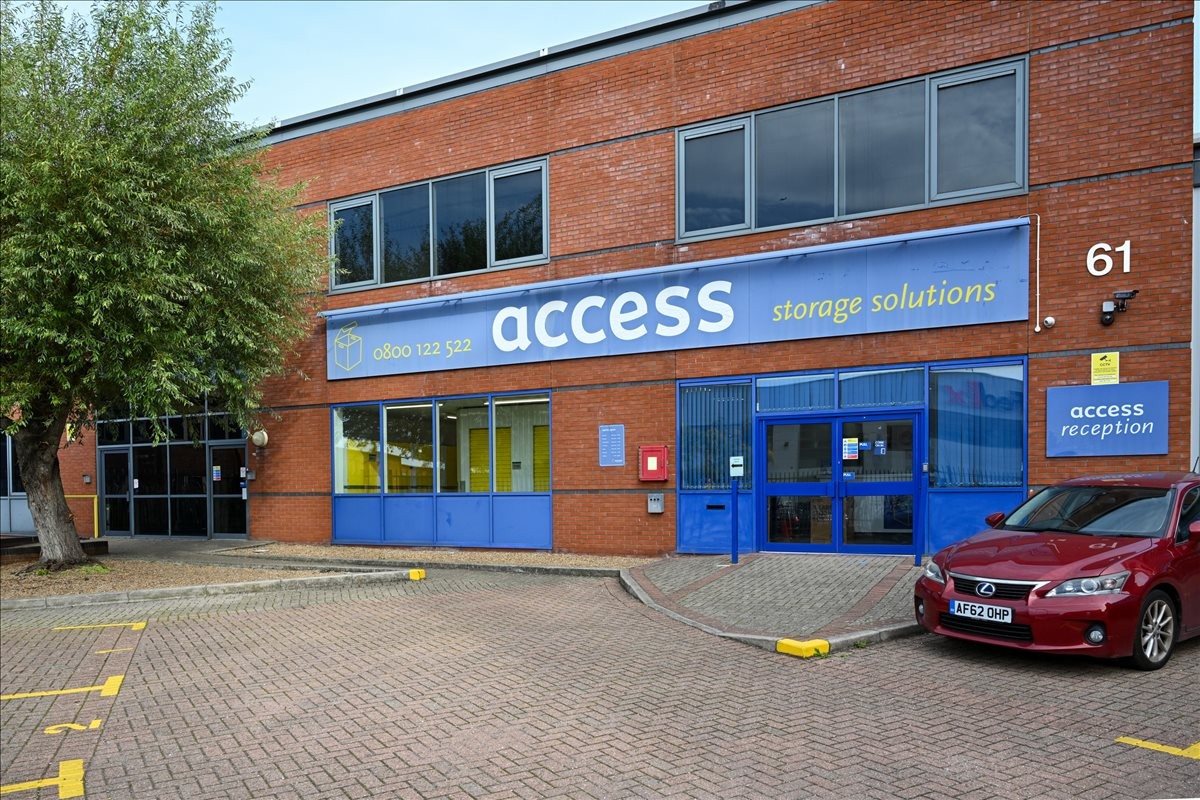 Exterior brick facade of 61 Willow Walk featuring prominent blue signage.