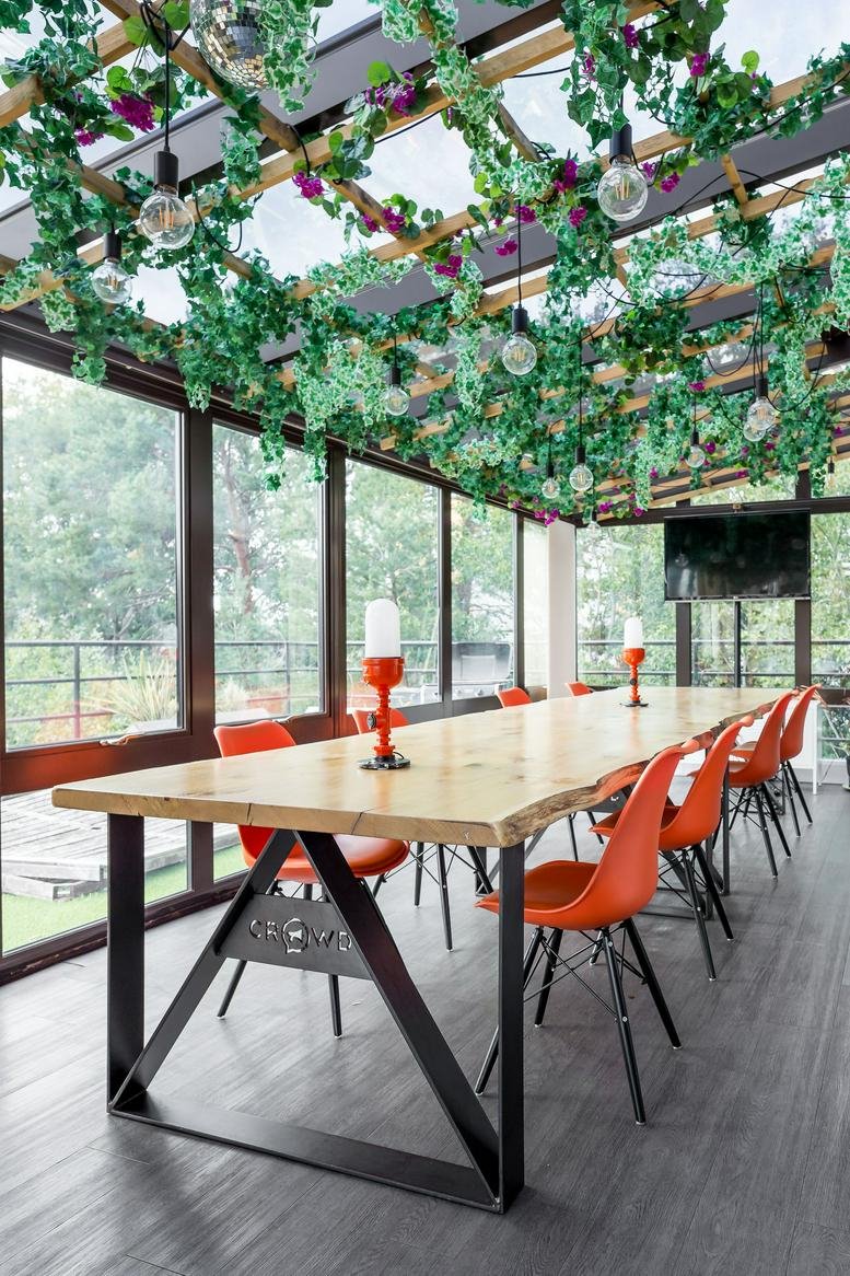 Bright meeting room at Wilson House, 2 Lorne Park Road, featuring a long wood table and ceiling vines.