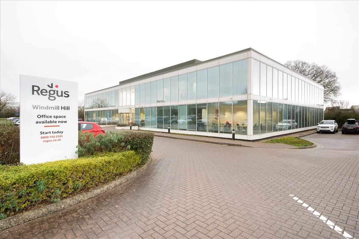 Exterior view of the glass-walled professional building at Windmill Hill Business Park.