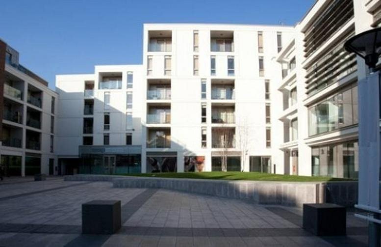 Exterior view of the modern white-facade Wingate Business Exchange building at 64-66 Wingate Square.