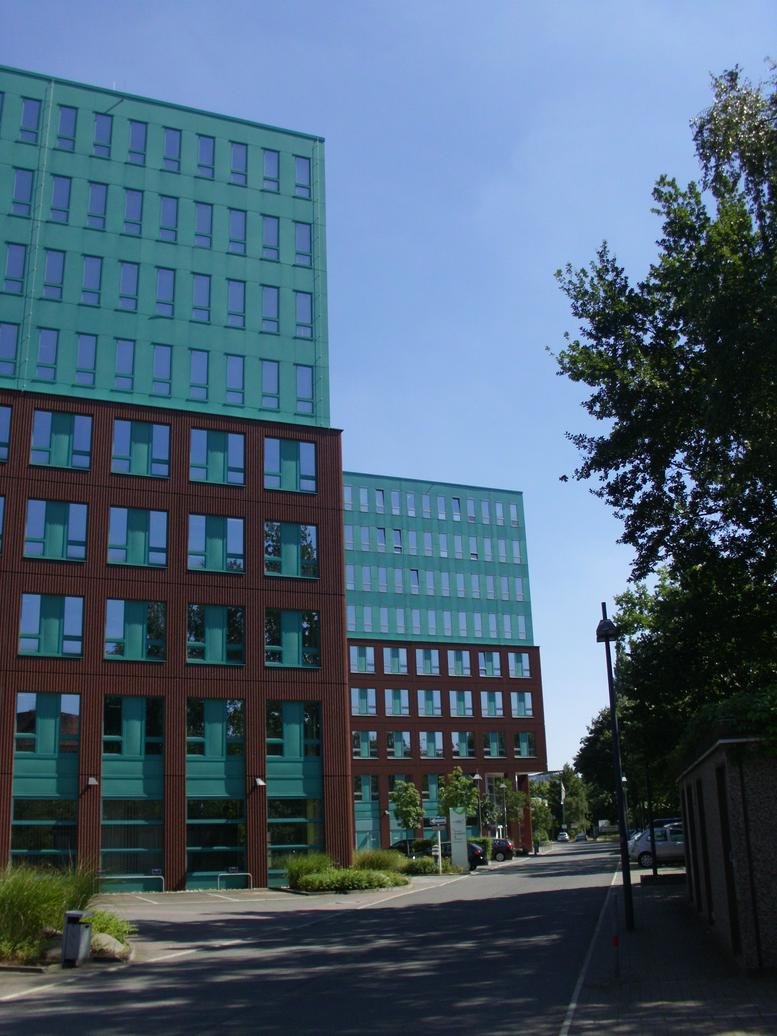 Exterior view of the office building with blue and red facade.
