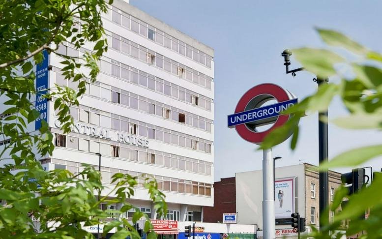 Exterior view of the white multistory York Hub, Popeshead Court Offices near a London Underground sign.