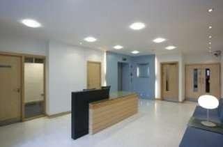 Bright, modern reception area at York Towers, 383 – 387 York Road featuring a wood-fronted desk and recessed lighting.