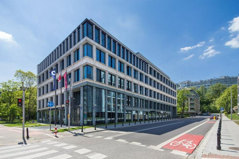 Exterior view of the modern glass and stone facade at Zajęcza 15, Warsaw, Poland.