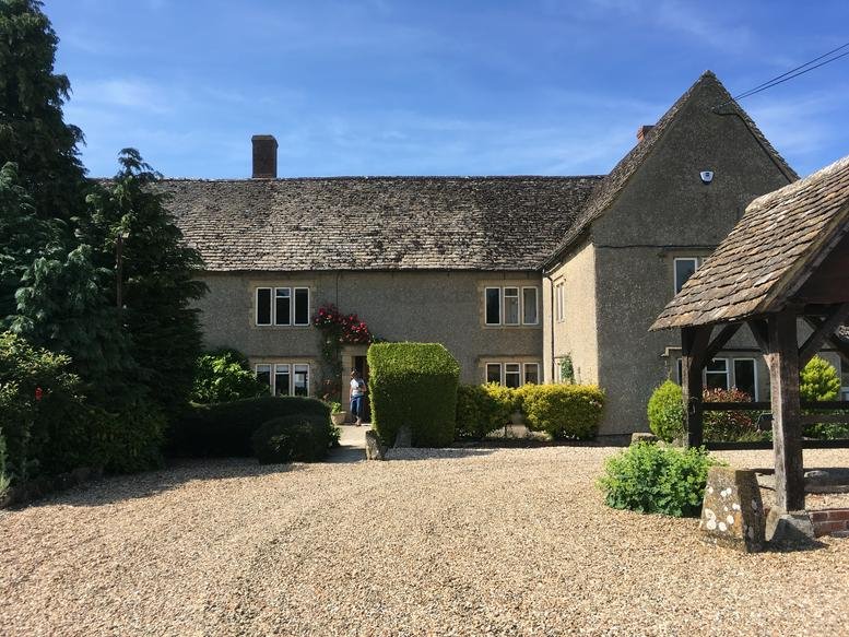 Exterior view of the stone facade at Old Swindon Road, Royal Wootton Bassett, Wiltshire with gravel forecourt.