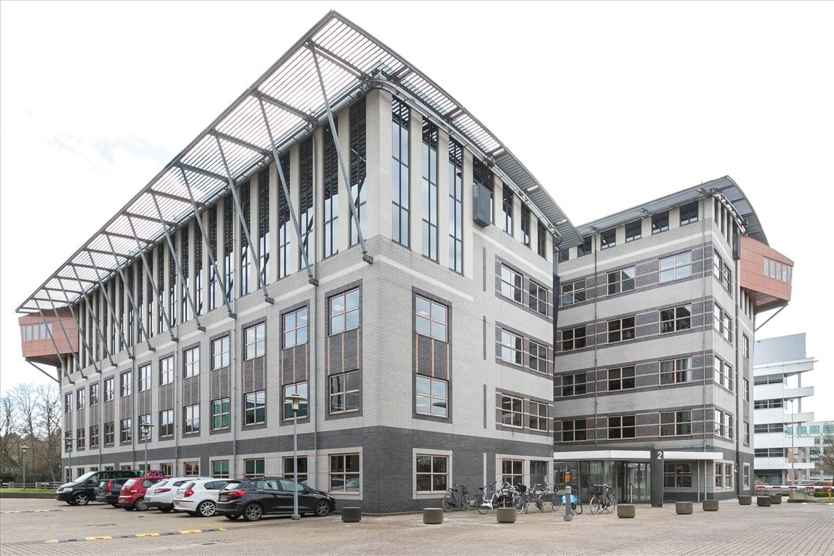 Exterior view of the modern OLYMPIA 2D building with its unique tiered roof and large glass windows.