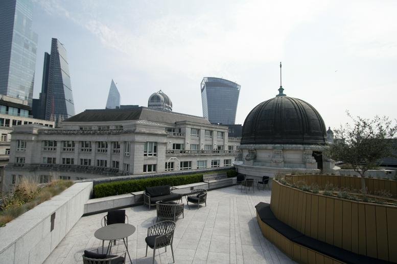 Roof terrace at One King William Street with outdoor seating and views of the City of London skyline.