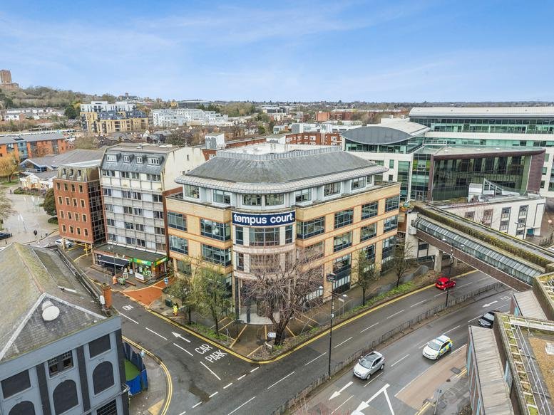 Wide exterior view of the Tempus Court building facade at a town intersection.