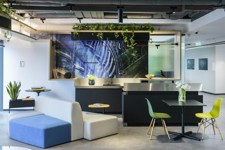 Colorful lounge area and reception desk at the Orhideea Towers with a vibrant botanical mural.