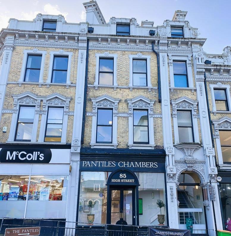 Grand facade of Pantiles Chambers featuring ornate white stonework and large windows.