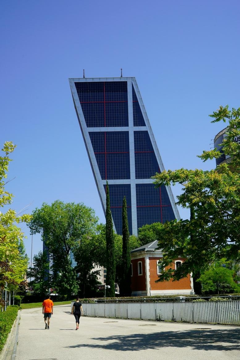 Exterior view of the striking tilted glass towers at Paseo de la Castellana, 216, Madrid.