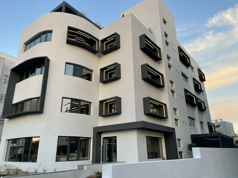 Exterior view of the modern white and black facade of Patmou 14, Maroussi, Greece.