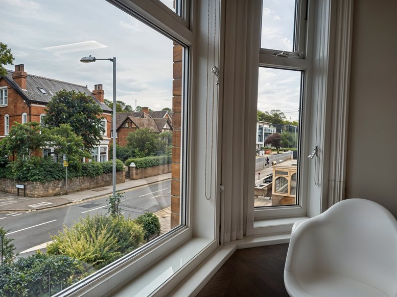 Full exterior view of the traditional brick office building under a blue sky.