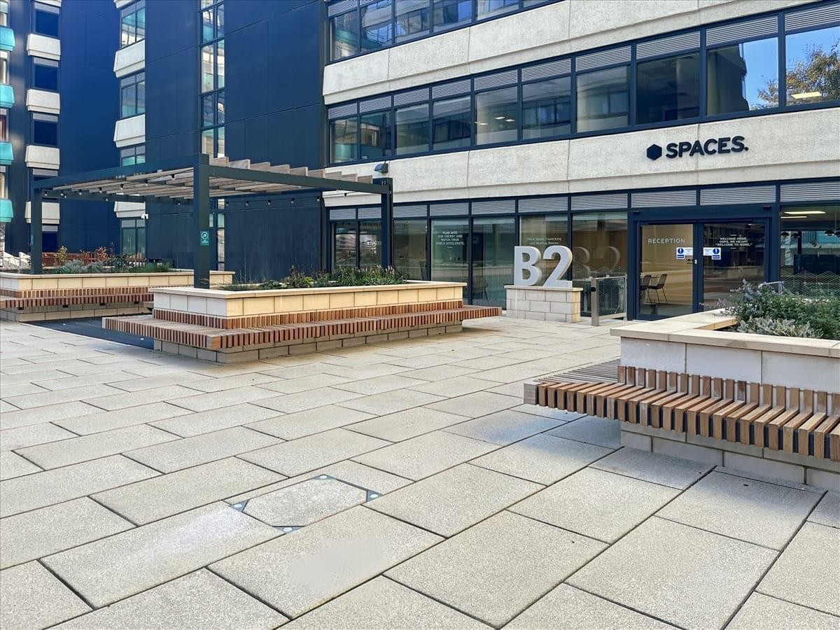 Exterior entrance area of Pennine 5 Tenter Street, Block 2, Sheffield with modern paving and wooden benches.