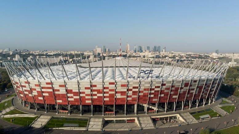 Aerial view of the red and white PGE Narodowy stadium exterior in Warsaw.