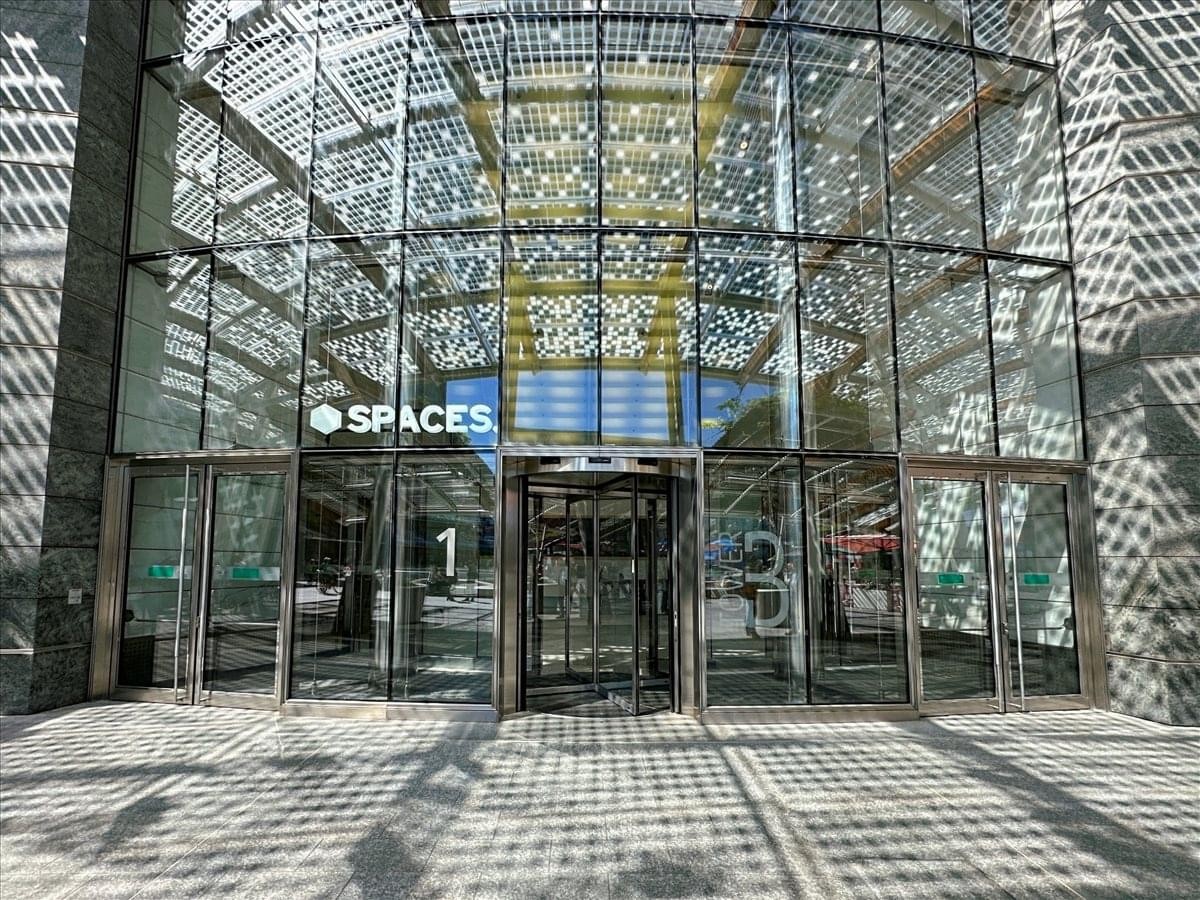 The glass entrance of Torre B, Piazza Gae Aulenti 3, Porta Nuova, Milan showing the Spaces logo.