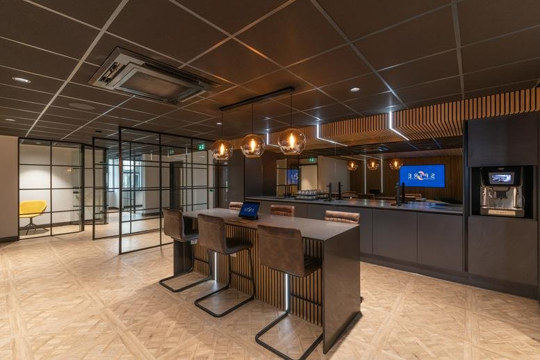 Spacious communal breakout area at Pilgrim Street, The Spire, with high tables, pendant lighting and kitchen facilities.