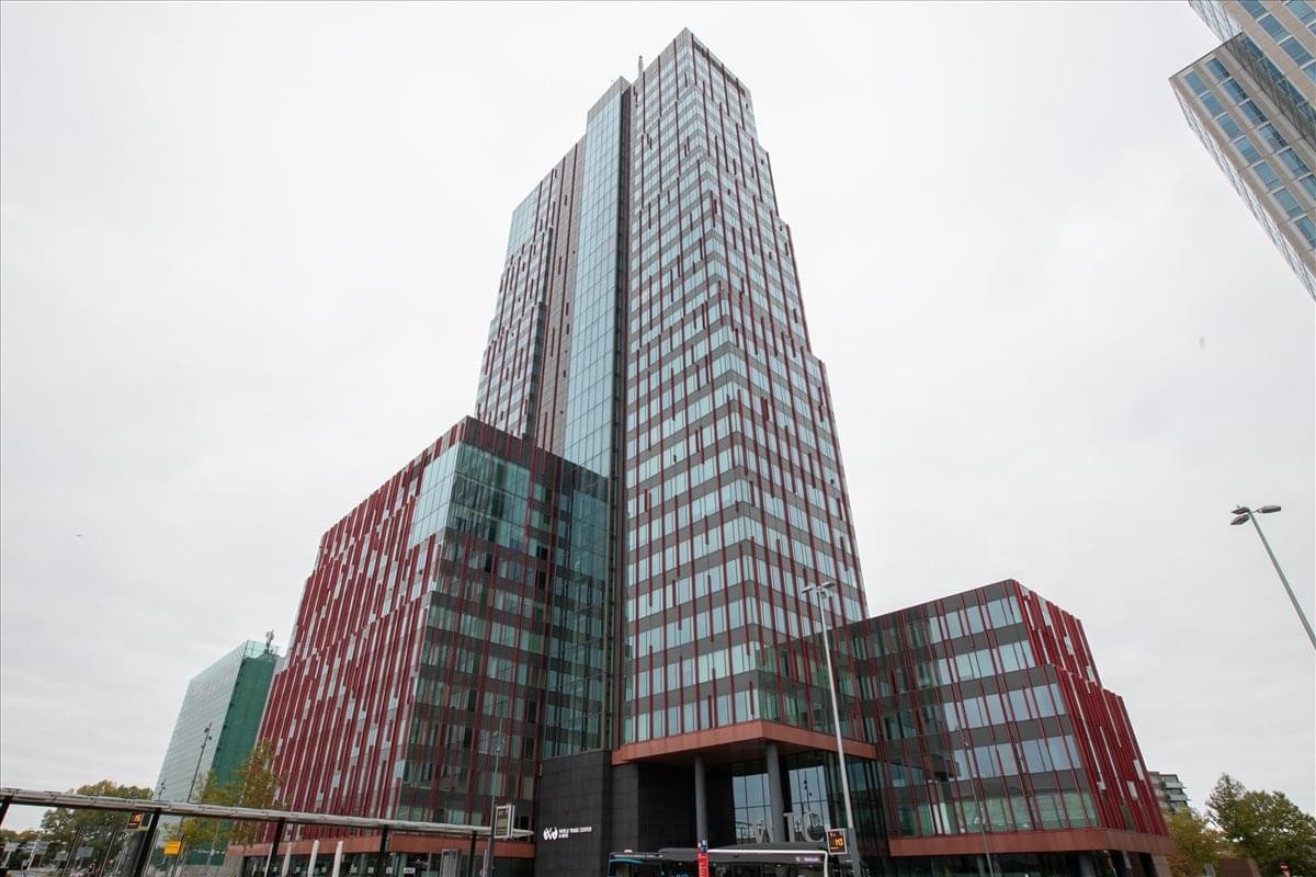 Exterior view of the modern glass and red facade at P. J. Oudweg 4, Almere, Flevoland.