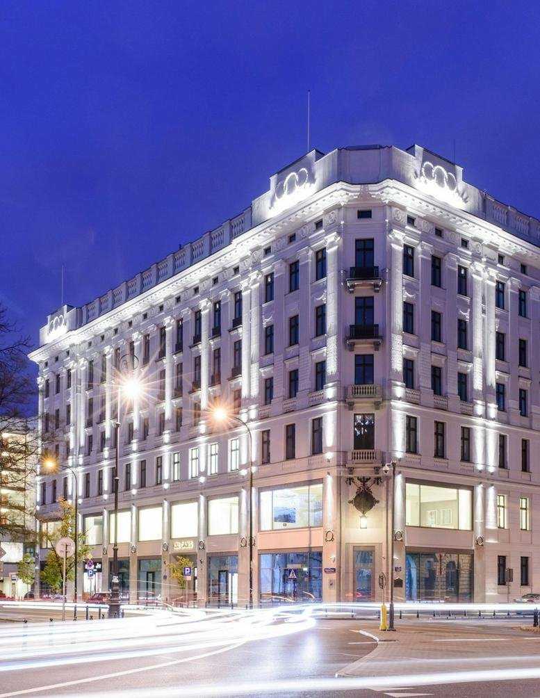 Exterior view of the historic white facade building at Plac Stanisława Małachowskiego 2.
