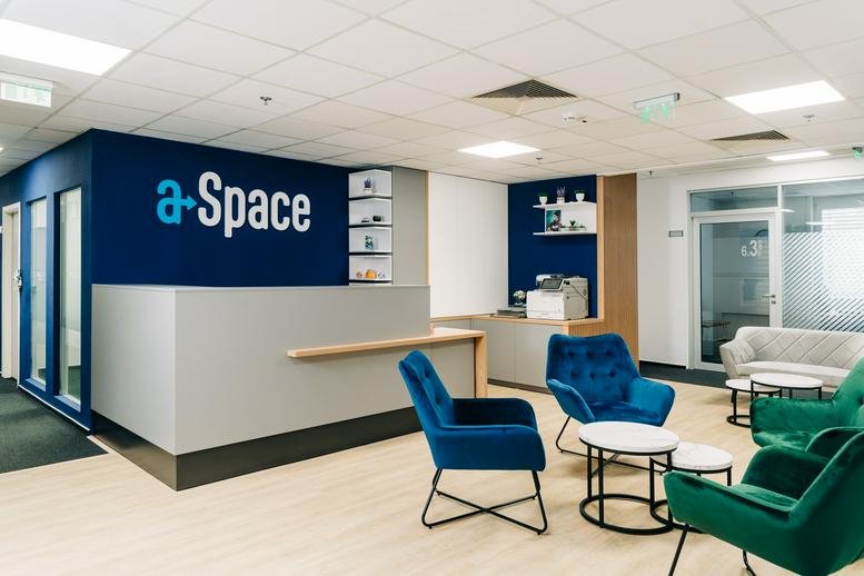 Bright reception area at Ploiesti Street, No. 19-21, 6th and 8th floors, Bucharest with blue and green velvet armchairs.