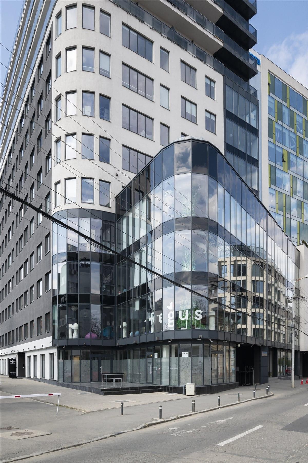 Modern glass and white facade of the Ploiesti Street, No. 9, Cluj Napoca building.
