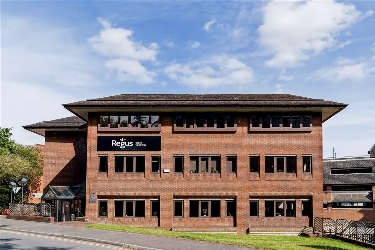 Front view of the brick office building under a blue sky.