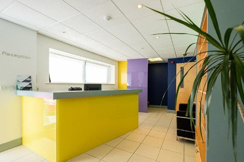 Reception area at Port Tunnel Business and Technology Park, Clonshaugh, Dublin 17 with a yellow desk and purple accents.