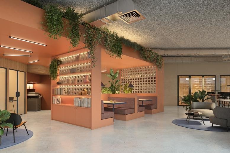 Co-working lounge with terraced wooden seating, integrated bookshelves, and lush greenery.