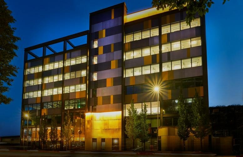Evening view of the modern multi-colored facade at Preston Barracks, Lewes Road.