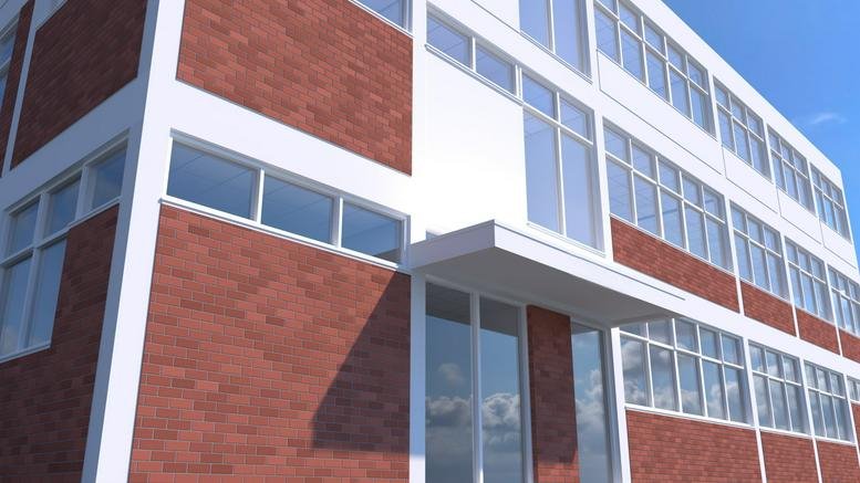 The brick and white facade of Princess House, Horace Road, London with large grid windows.