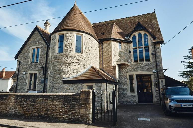 Exterior view of the historic stone-built St Edburgs Hall on Priory Road.
