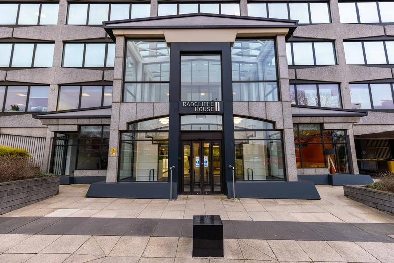 Exterior view of the modern glass and stone facade at Radcliffe House Business Centre.
