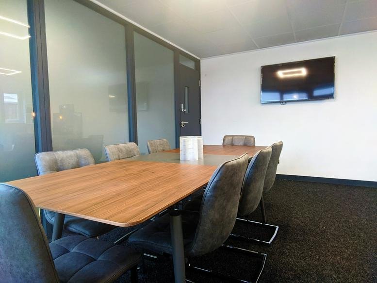 Meeting room at Radley House, Richardshaw Road featuring a large wood-finish table and mounted screen.