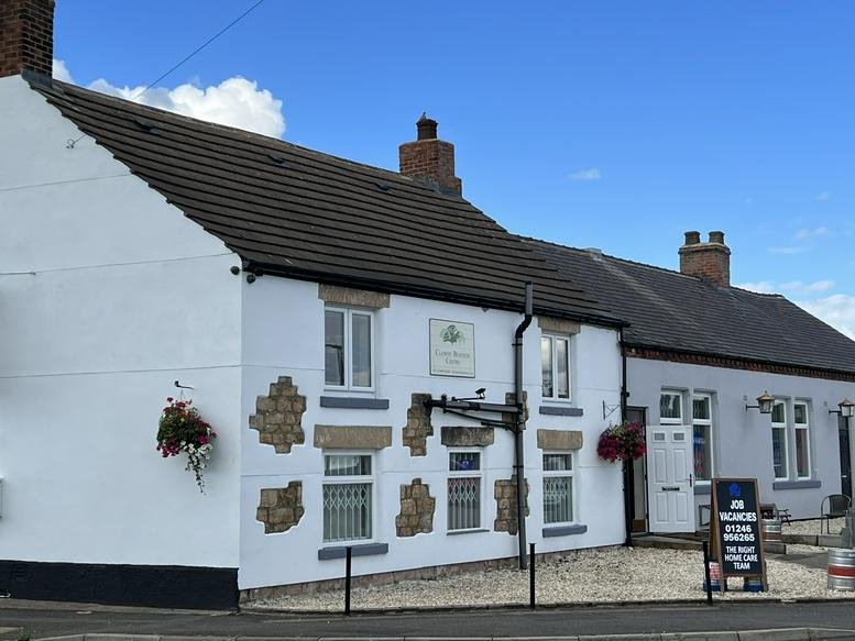 Exterior view of the white Ravenshorn Way, Renishaw, Derbyshire building with traditional stone accents.