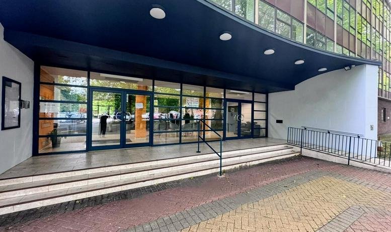 Exterior entrance of Regent House with wide steps and a dark blue modern canopy.