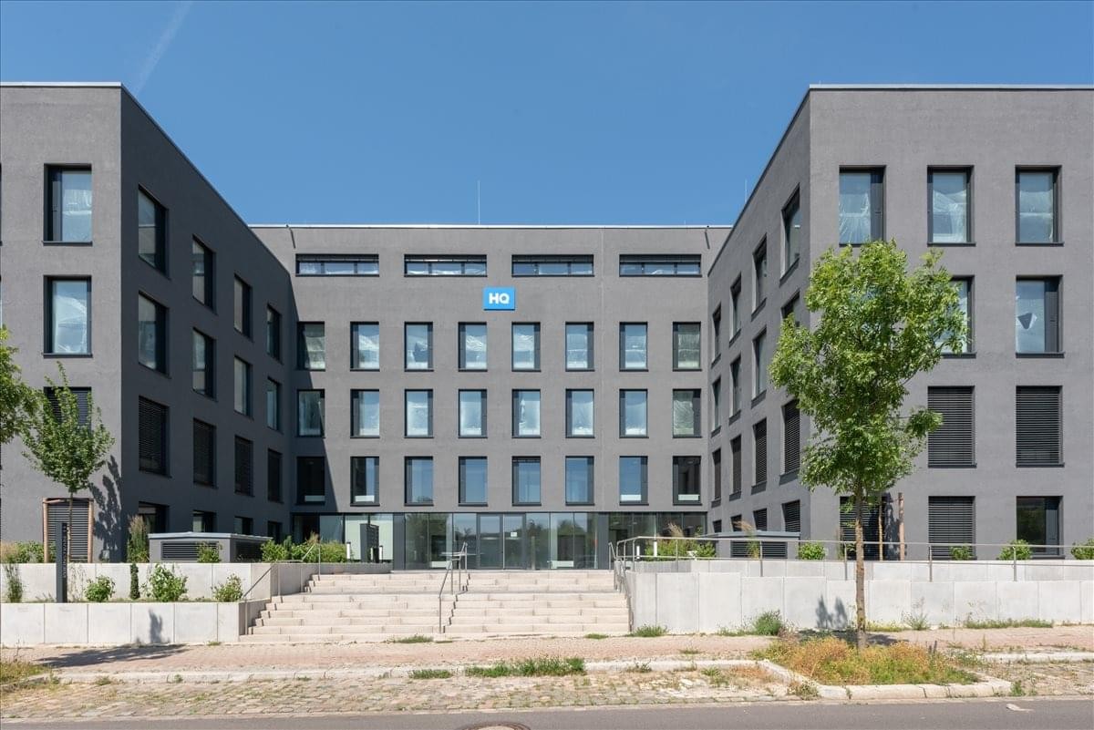 Exterior view of the modern grey brick building at Regus HQ, Rheinstrasse 11.