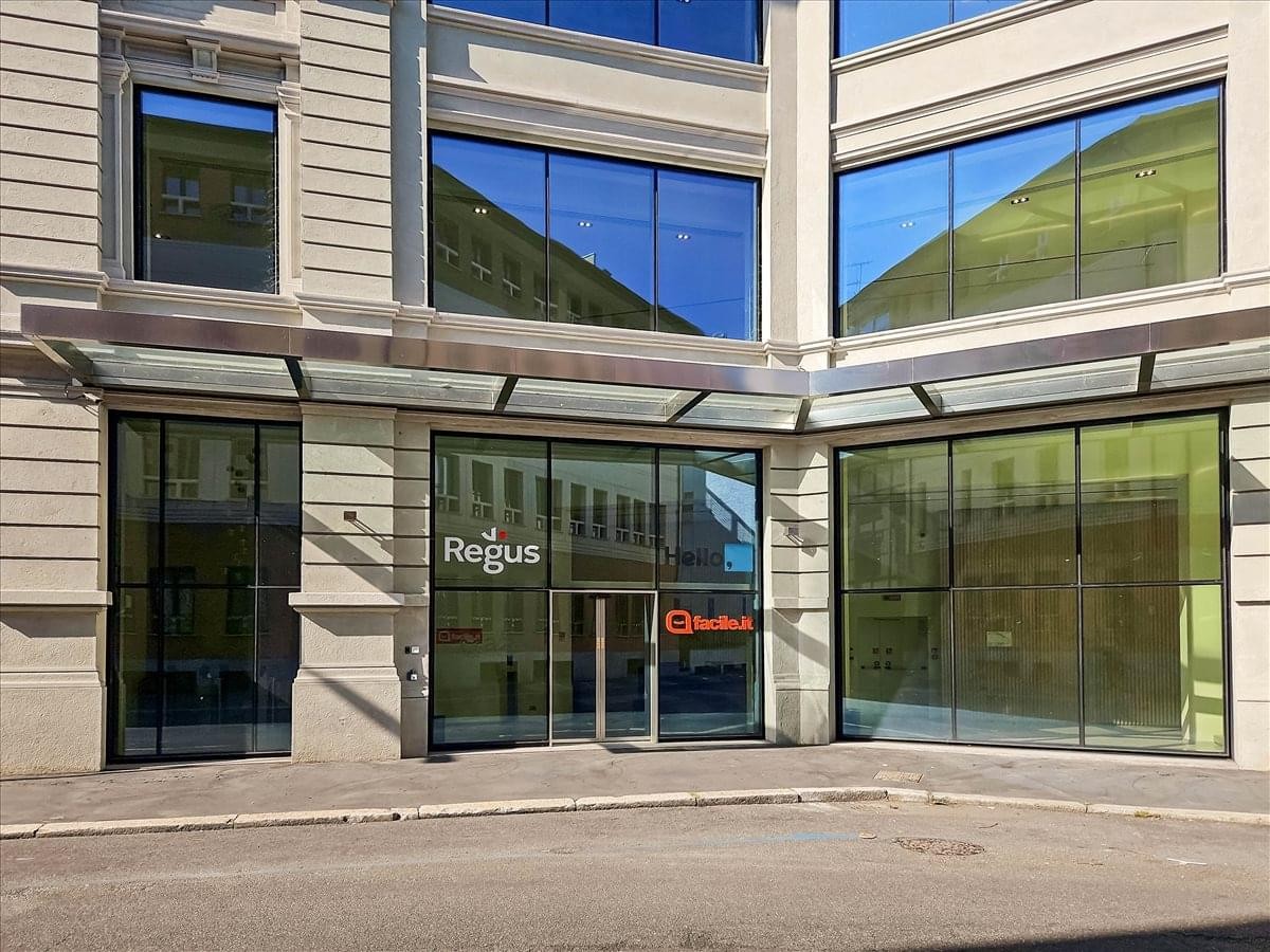 Exterior entrance view of the modern stone and glass facade at Regus Piazzale Lodi, Via Sannio, 3.