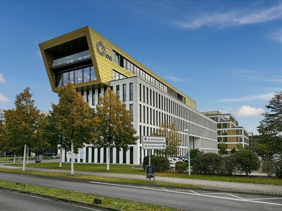Exterior view of the modern, gold and white building at Rheinpromenade 4a in Monheim am Rhein.