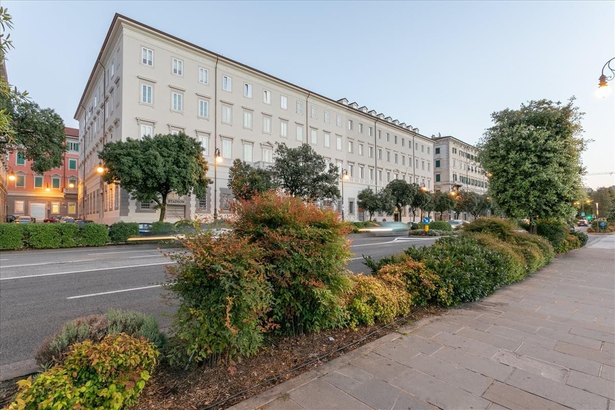 Grand multi-story facade of the Riva Tommaso Gulli 12 building with classical architecture.