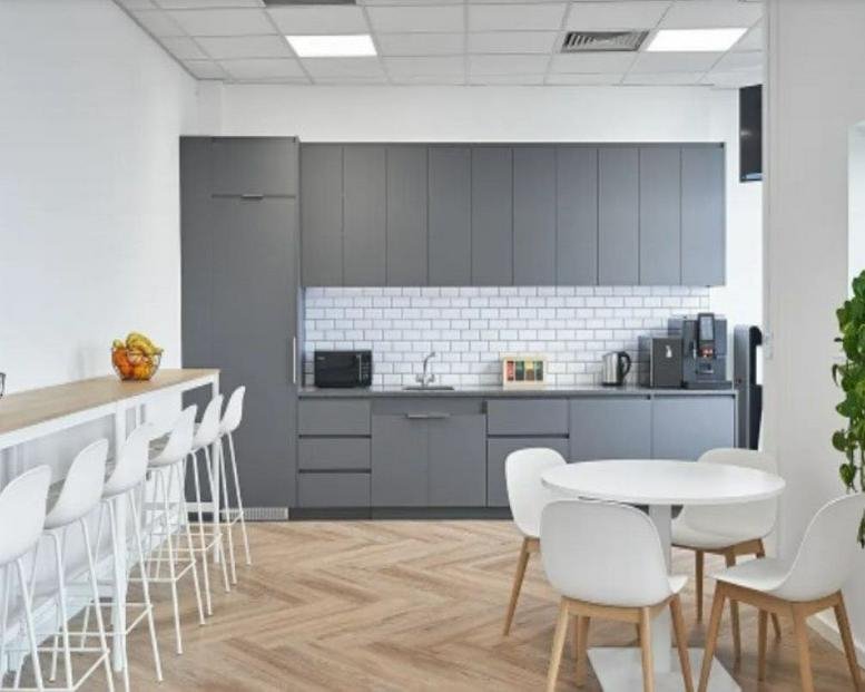 Modern communal kitchen at Riverview House 23 City Quay with grey cabinetry and a breakfast bar.