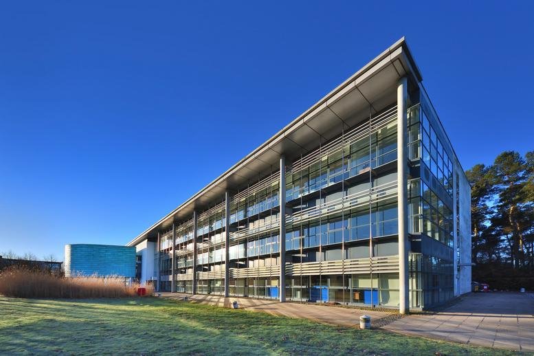 Exterior view of the contemporary glass and steel facade of The Alba Centre.