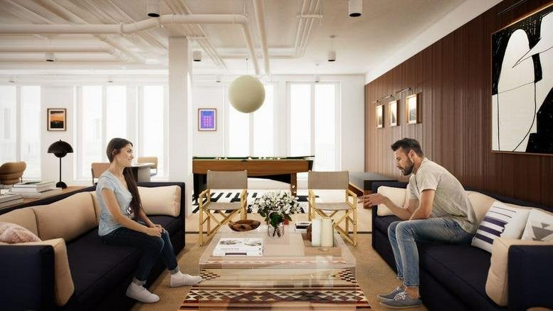 Spacious communal lounge at Rosenthaler Straße 43-45 with dark sofas and a wooden pool table.