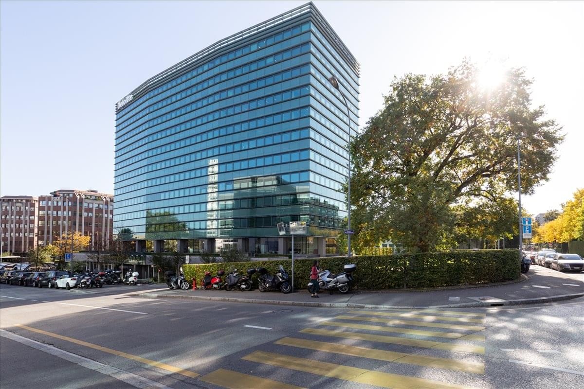 Exterior view of the multi-story glass facade of the Nations Business Center building.