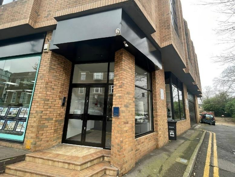 Exterior entrance of Saint James House, 9 Saint James Road, Surbiton, featuring brickwork and a modern black canopy.