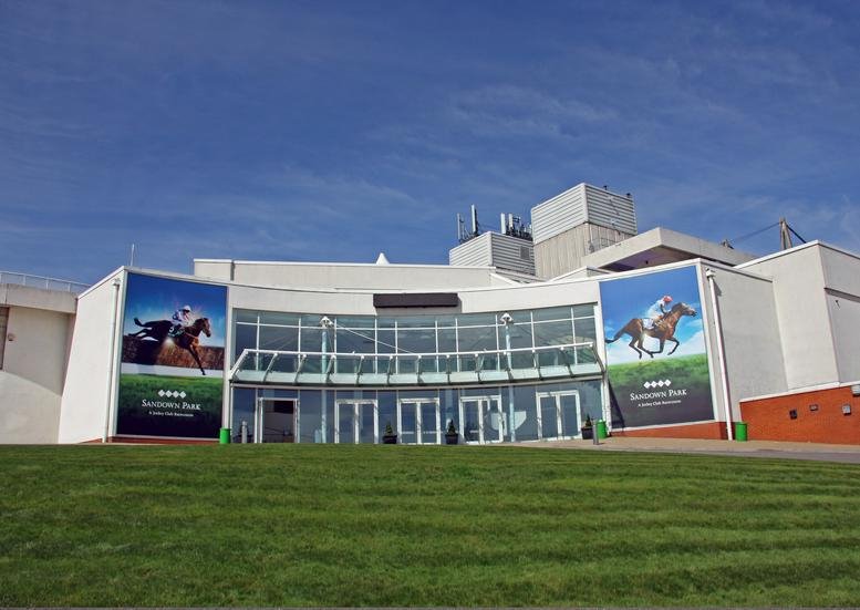 Exterior view of the white facade and entrance of Sandown Park Racecourse, Portsmouth Road, Surrey, Esher.