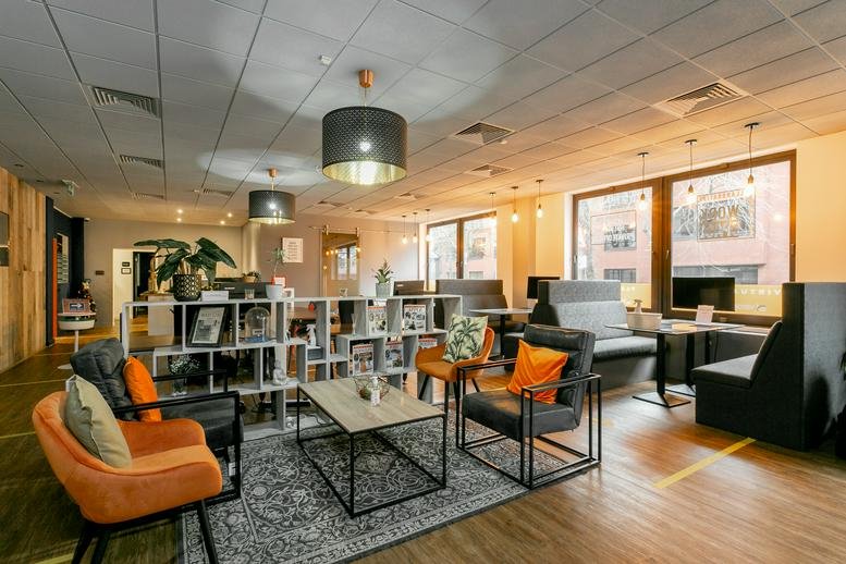 Spacious communal lounge at Saxon House, 27 Duke Street with colorful armchairs and modern lighting.